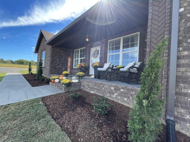 exterior space featuring a porch and brick siding