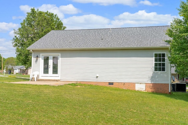 back of property featuring a lawn, french doors, roof with shingles, and crawl space