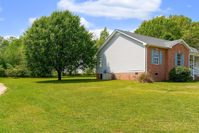 view of side of home featuring a yard, crawl space, central AC unit, and brick siding