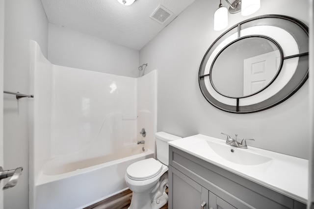 full bath with visible vents, vanity, toilet, shower / tub combination, and a textured ceiling