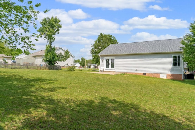 view of yard with a patio area, fence, and french doors