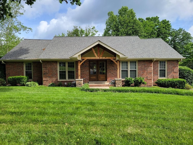 ranch-style house featuring french doors, brick siding, a shingled roof, and a front lawn