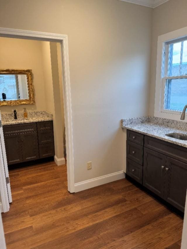 500 Brown St, Celina, TN 38551 - bathroom featuring wood finished floors, ornamental molding, baseboards, and two vanities