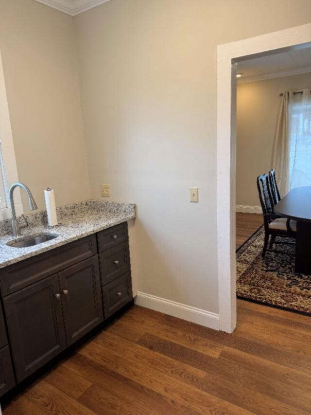 500 Brown St, Celina, TN 38551 - bar area featuring ornamental molding, a sink, dark wood-type flooring, and baseboards