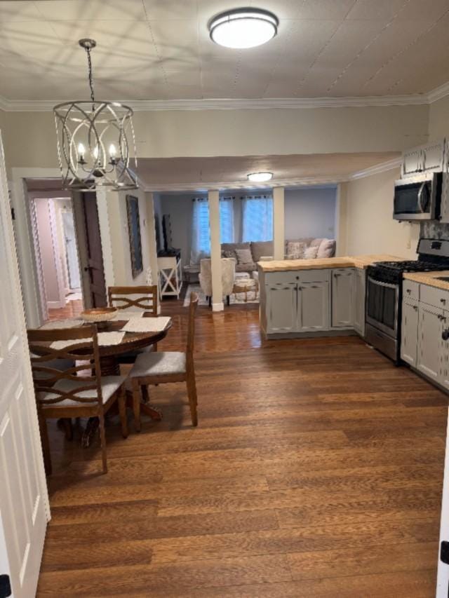 500 Brown St, Celina, TN 38551 - dining area featuring dark wood-style flooring, a chandelier, and crown molding