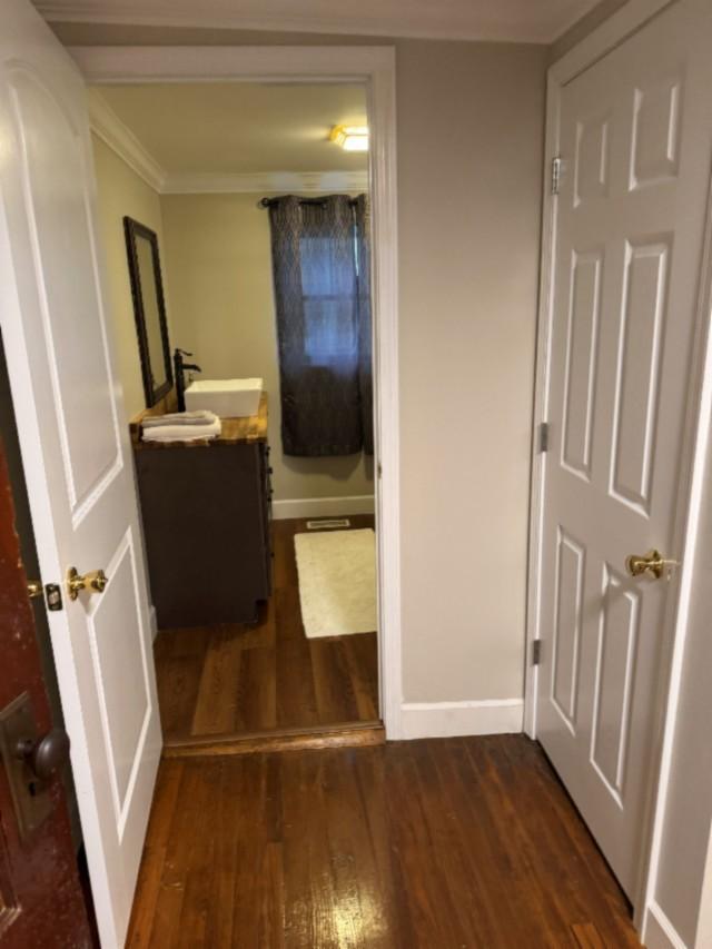 500 Brown St, Celina, TN 38551 - hallway featuring a sink, dark wood-style flooring, crown molding, and baseboards