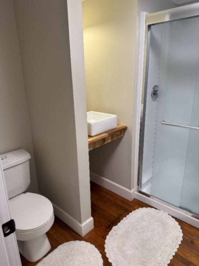 500 Brown St, Celina, TN 38551 - full bathroom featuring a stall shower, wood finished floors, baseboards, and toilet