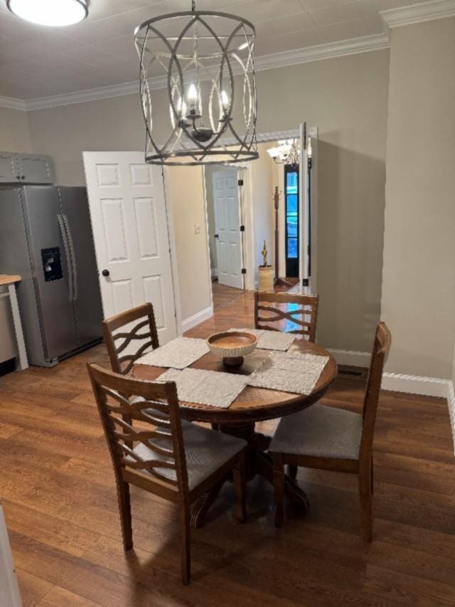 500 Brown St, Celina, TN 38551 - dining area with a chandelier, crown molding, wood finished floors, and baseboards