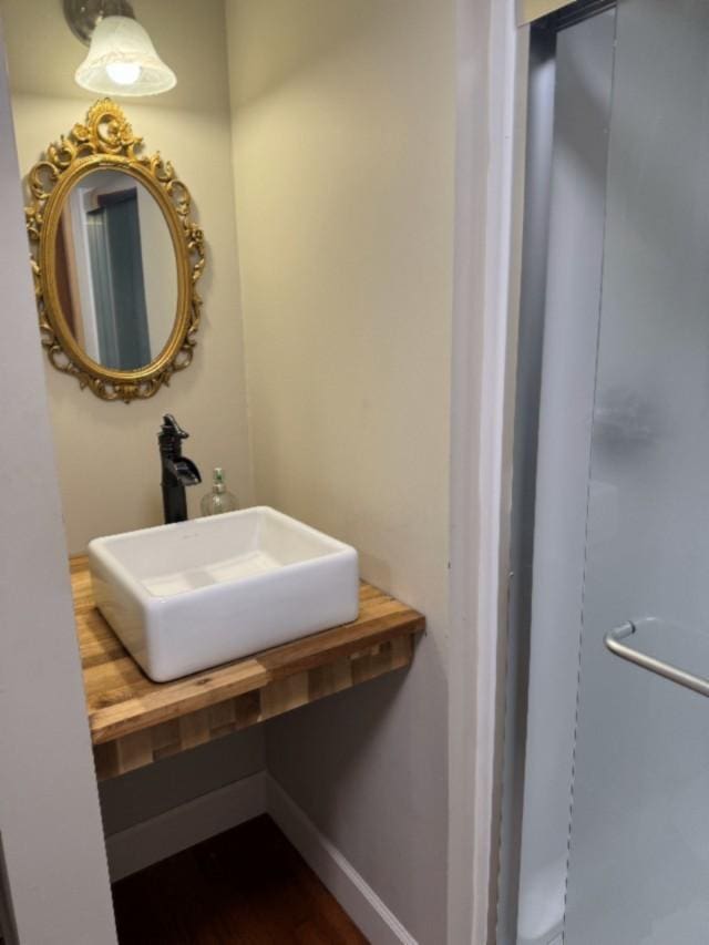 500 Brown St, Celina, TN 38551 - bathroom featuring a sink, baseboards, and wood finished floors