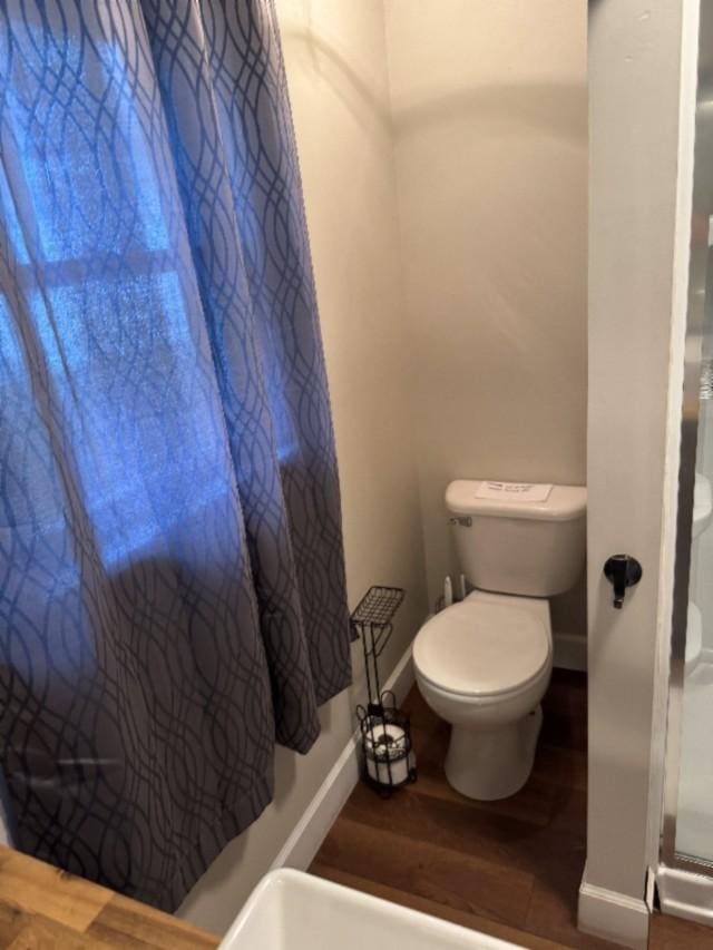 500 Brown St, Celina, TN 38551 - full bath featuring toilet, baseboards, wood finished floors, and a shower