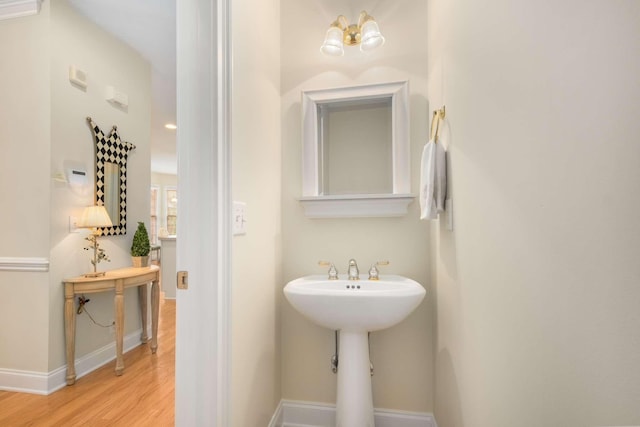 bathroom featuring baseboards and wood finished floors
