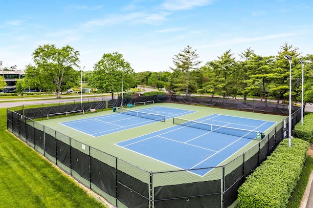 view of sport court featuring fence