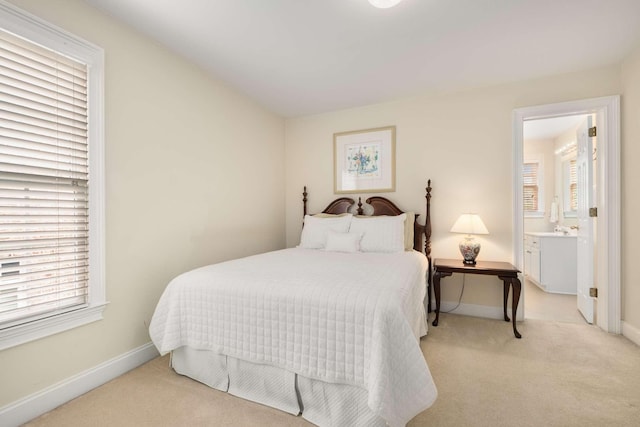 bedroom with baseboards, multiple windows, and light carpet