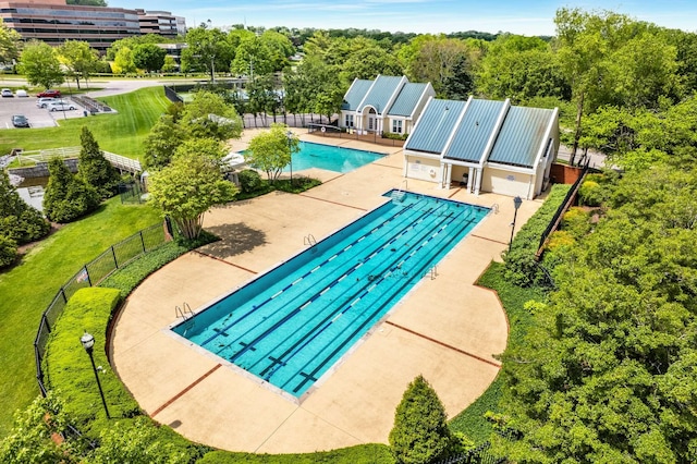 community pool featuring a patio and fence