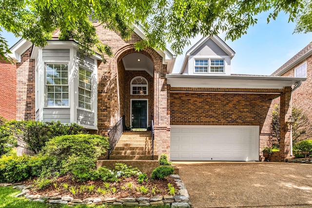 view of front of home featuring brick siding, a garage, and concrete driveway