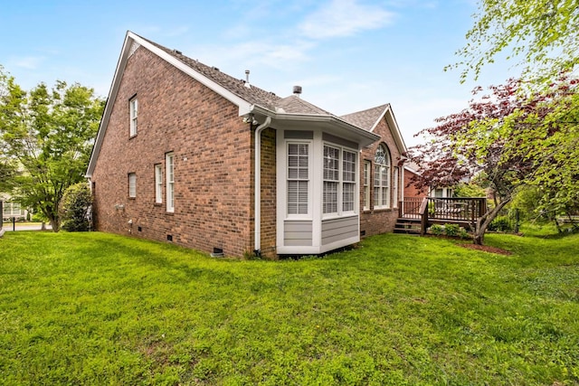 view of property exterior featuring a shingled roof, brick siding, a wooden deck, crawl space, and a lawn