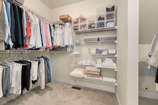 spacious closet featuring carpet flooring and visible vents