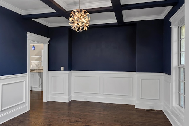 unfurnished dining area featuring beamed ceiling, a chandelier, wainscoting, and a decorative wall