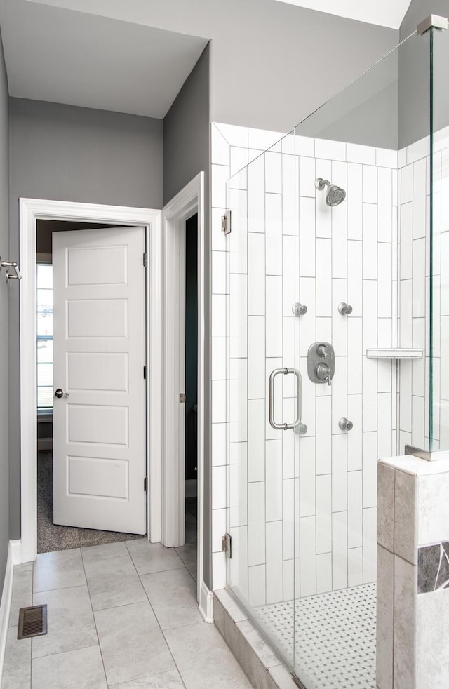 full bathroom featuring visible vents, tile patterned flooring, and a shower stall