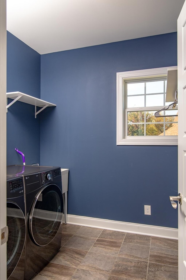 washroom with independent washer and dryer, laundry area, and baseboards