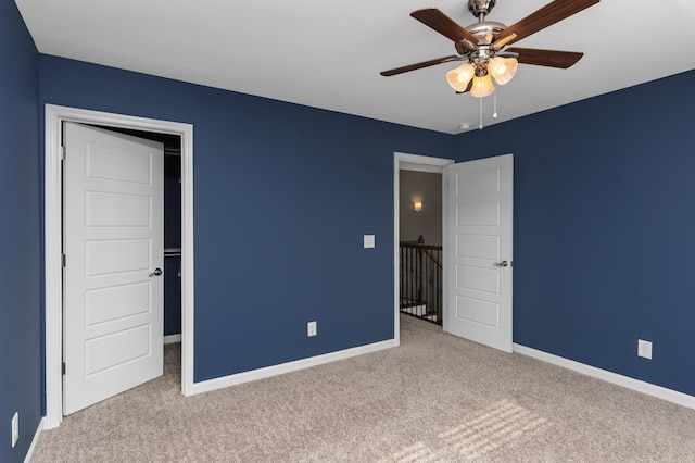 unfurnished bedroom with carpet floors, baseboards, and ceiling fan