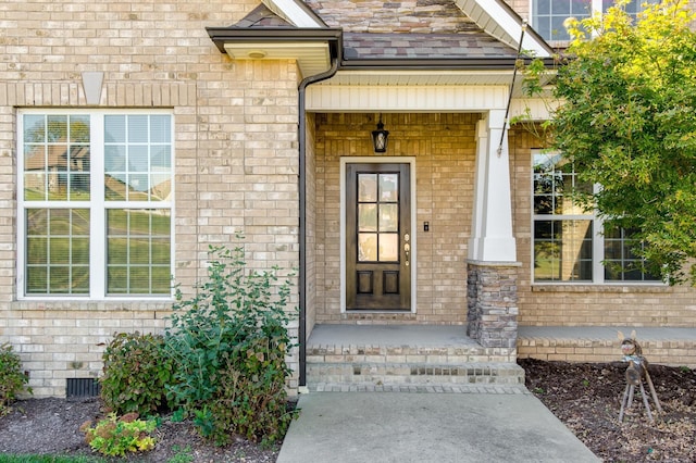 doorway to property with brick siding