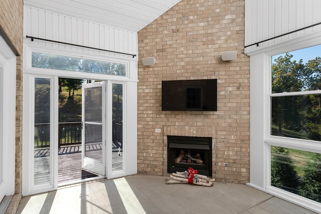interior space featuring a brick fireplace and vaulted ceiling
