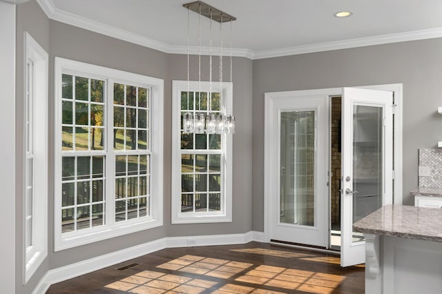 doorway with visible vents, ornamental molding, baseboards, recessed lighting, and dark wood finished floors