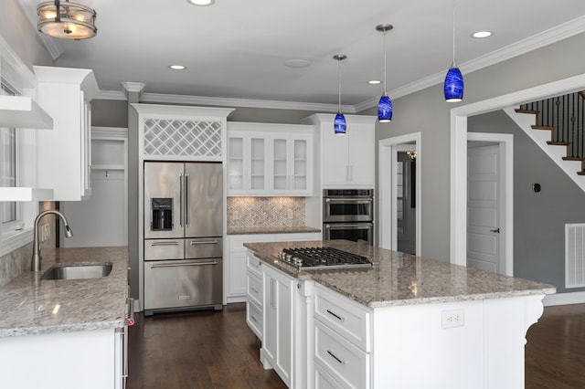 kitchen featuring a sink, dark wood-style flooring, appliances with stainless steel finishes, and white cabinets