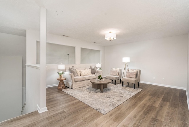 living area featuring baseboards and wood finished floors
