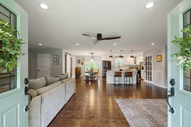 790 Noah Dr, Hohenwald, TN 38462 - living room with a ceiling fan, recessed lighting, a barn door, dark wood-style flooring, and visible vents