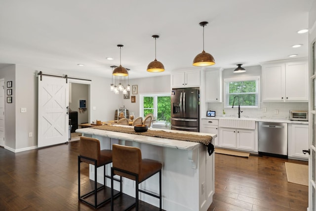 790 Noah Dr, Hohenwald, TN 38462 - kitchen with recessed lighting, a wealth of natural light, a barn door, and appliances with stainless steel finishes