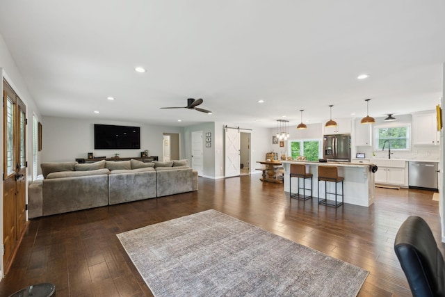 790 Noah Dr, Hohenwald, TN 38462 - living area with dark wood finished floors, a barn door, and recessed lighting