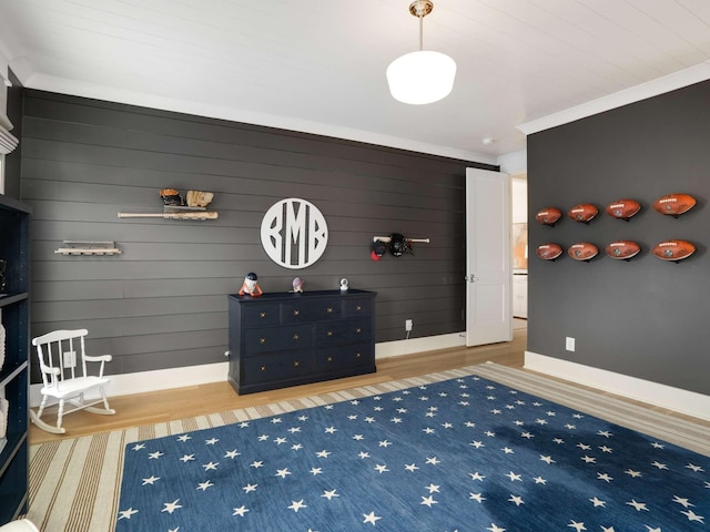 interior space with wooden walls, baseboards, and wood finished floors