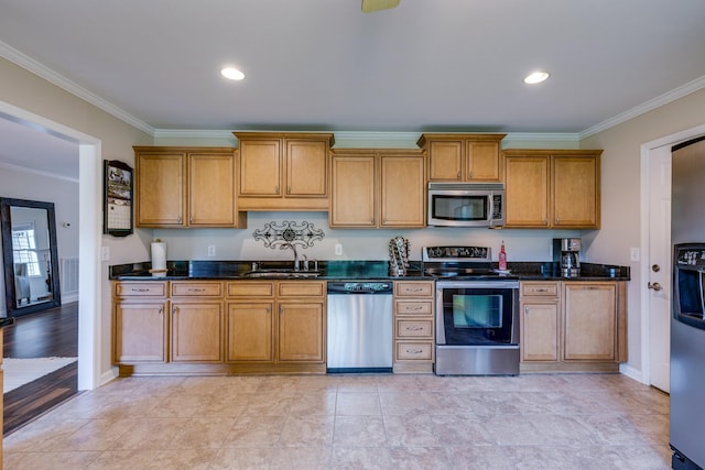 kitchen featuring crown molding, brown cabinets, appliances with stainless steel finishes, and a sink
