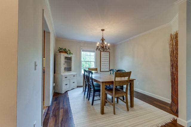 dining room featuring an inviting chandelier, ornamental molding, baseboards, and wood finished floors