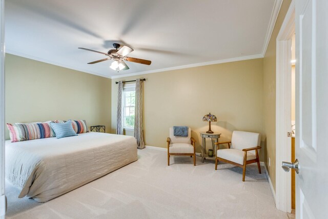 carpeted bedroom featuring baseboards, ornamental molding, and ceiling fan