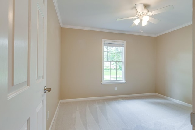 unfurnished room with carpet floors, crown molding, ceiling fan, and baseboards