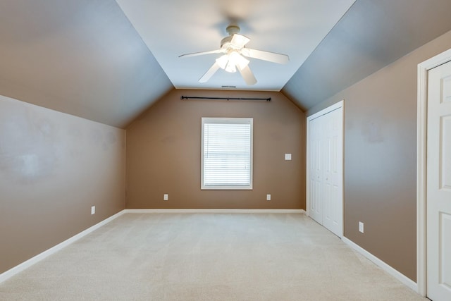 bonus room with baseboards, ceiling fan, vaulted ceiling, and light colored carpet