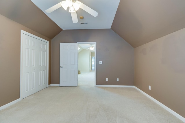bonus room featuring a ceiling fan, light colored carpet, visible vents, baseboards, and lofted ceiling