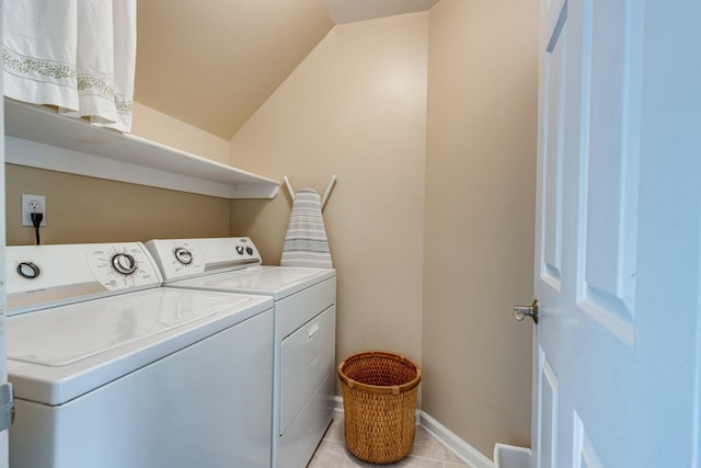 washroom with washing machine and clothes dryer, laundry area, baseboards, and light tile patterned floors