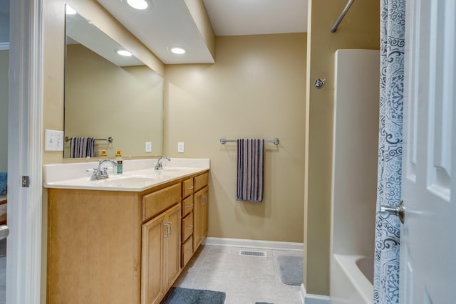 full bathroom with visible vents, double vanity, baseboards, tile patterned floors, and a sink