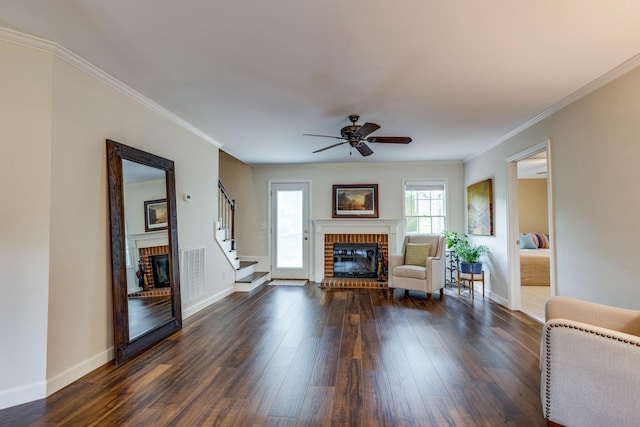 living area featuring baseboards, a fireplace, dark wood-style flooring, and visible vents