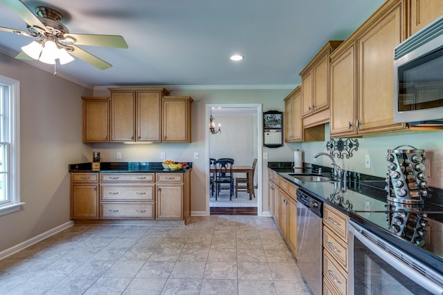 kitchen with crown molding, a sink, baseboards, and appliances with stainless steel finishes