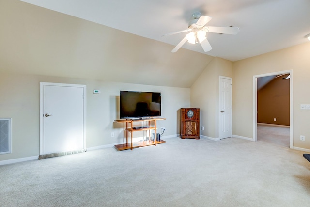 interior space featuring a ceiling fan, visible vents, vaulted ceiling, baseboards, and carpet flooring
