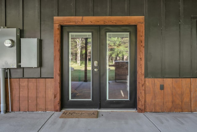 doorway to property featuring french doors and board and batten siding