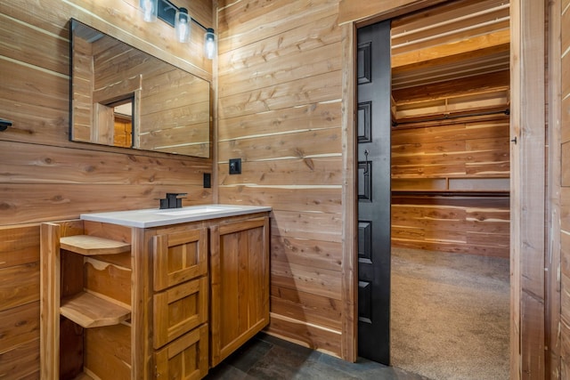 bathroom featuring wood walls and vanity