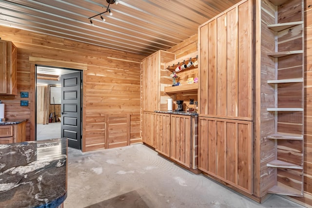 bar with wooden walls and unfinished concrete floors