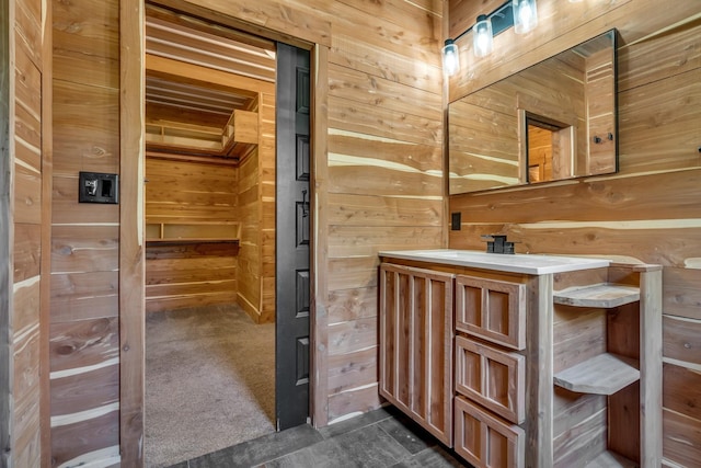 bathroom featuring wooden walls, vanity, and a sauna