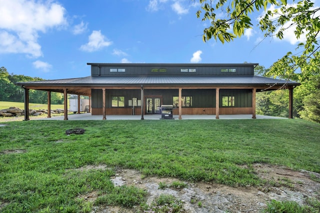 rear view of property featuring french doors and a lawn